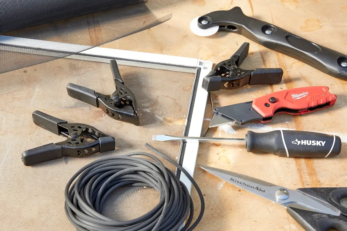 A window screen and tools needed to replace the screen and spline.