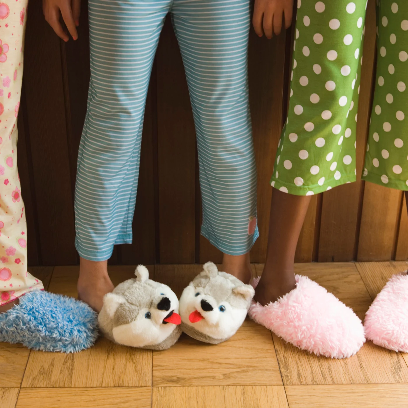 Pre-teen girls wearing fuzzy slippers